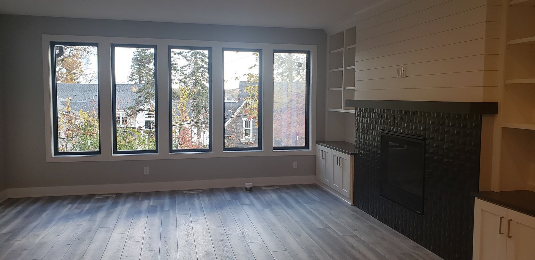 Great room with white walls and black-framed windows