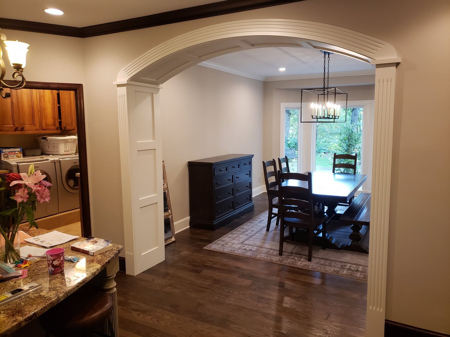 Arched opening into the dining room with white trim
