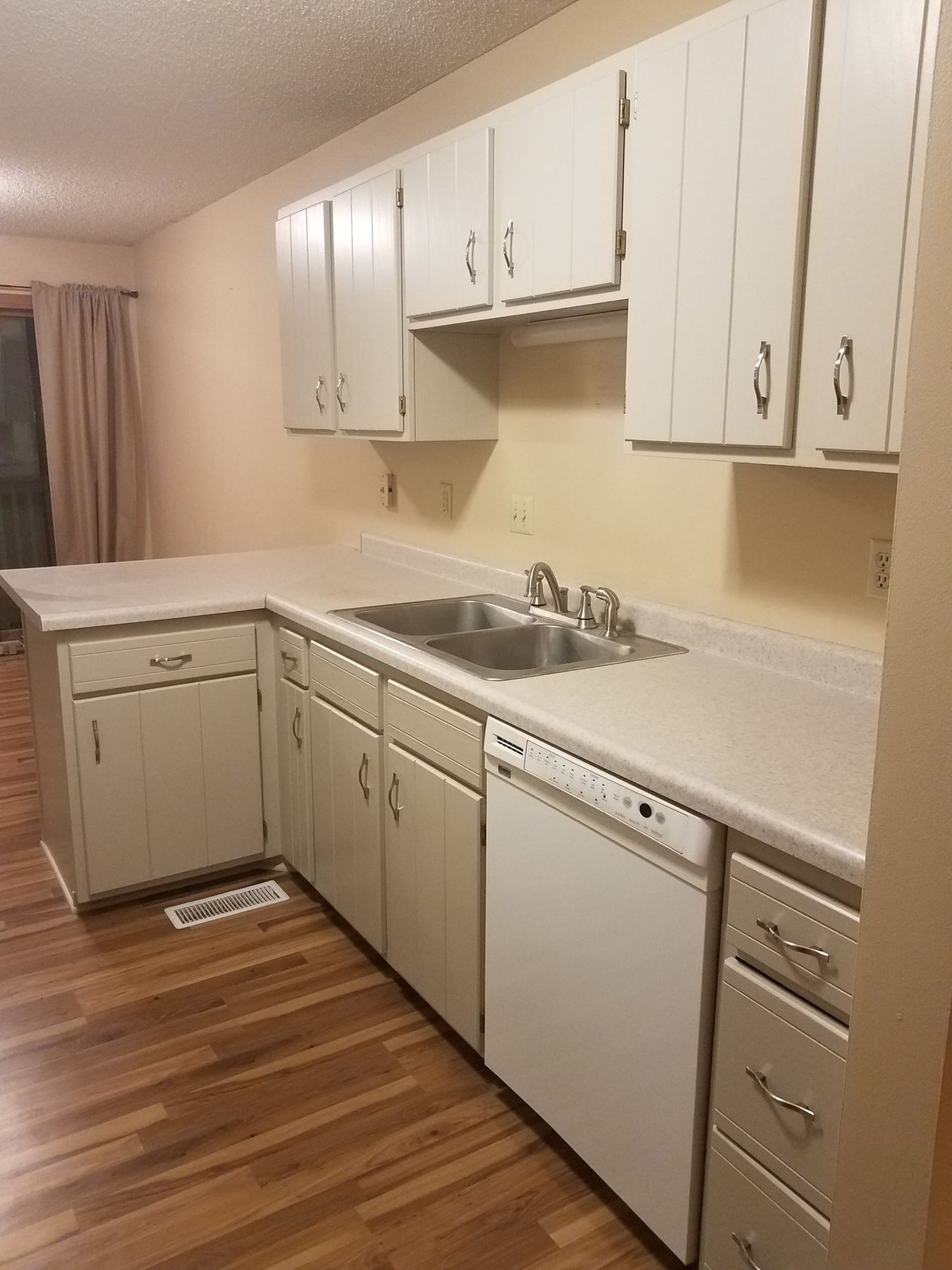 Painted cabinets along the sink wall