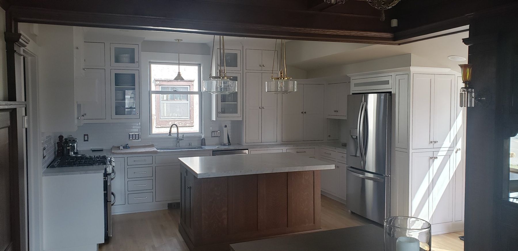 Kitchen island with original dark trim beyond