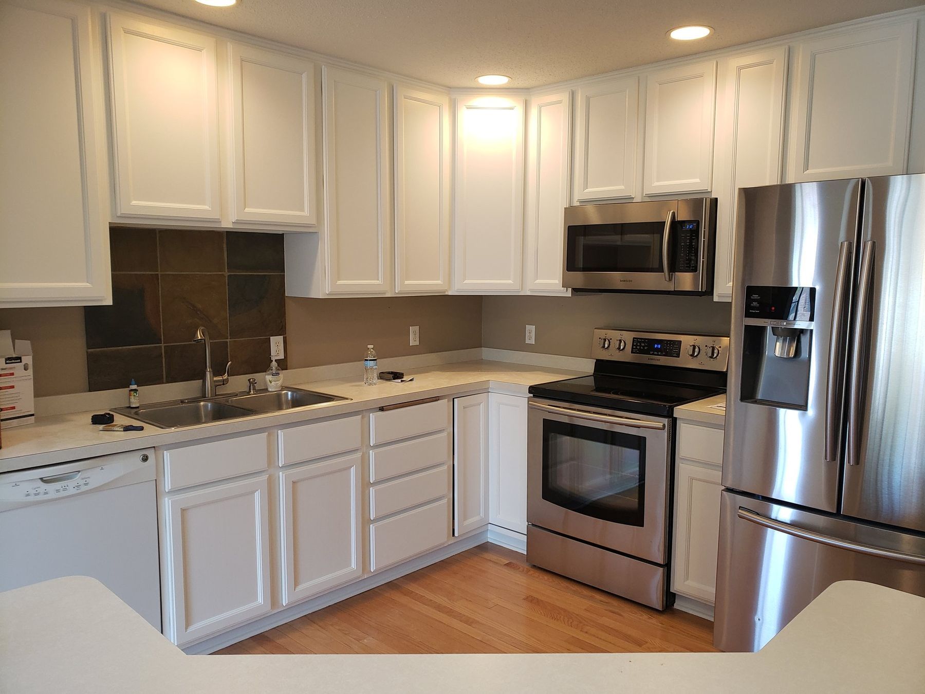 White kitchen cabinets and range wall