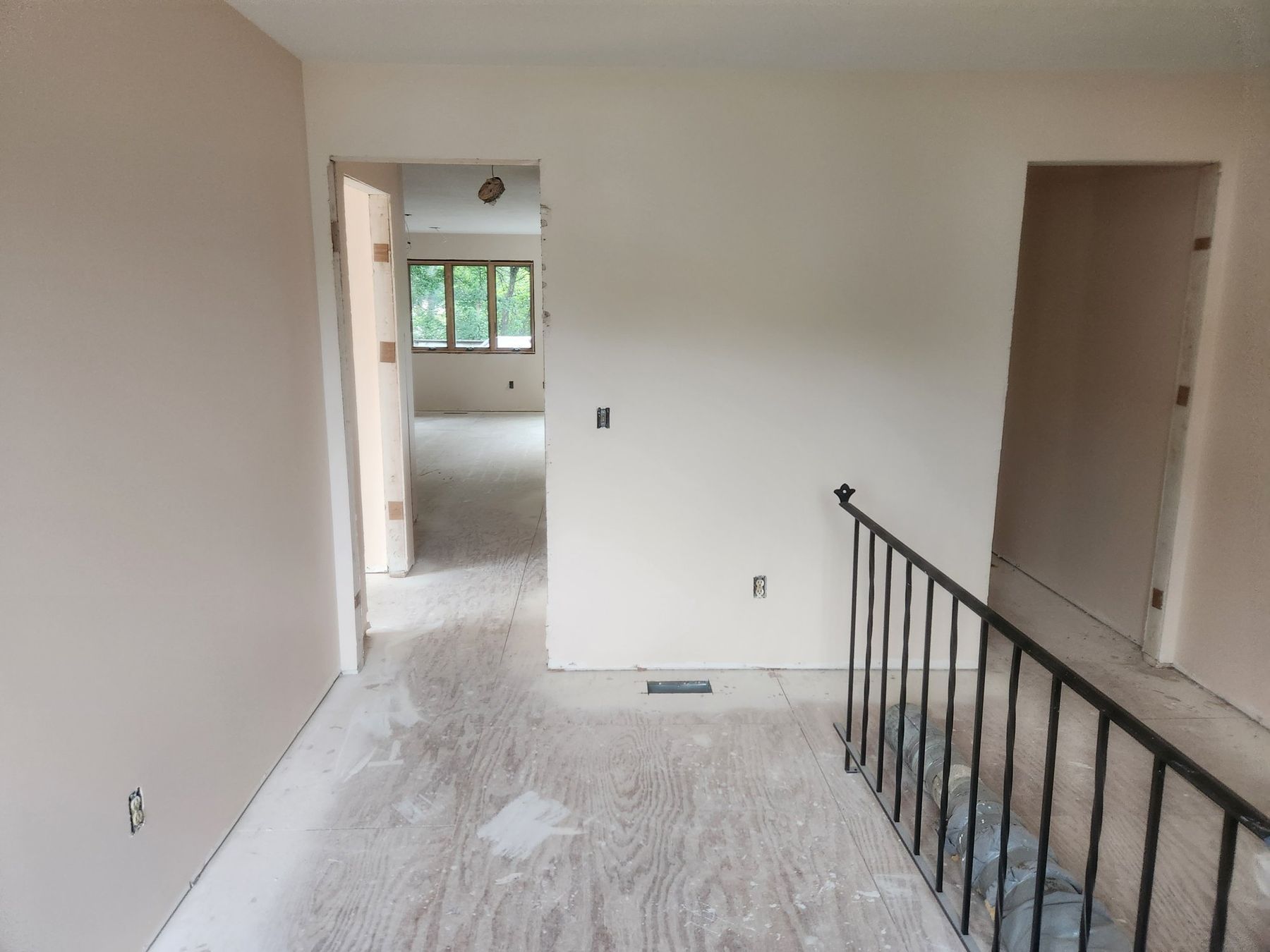 Primed walls and smooth ceiling toward the stairs