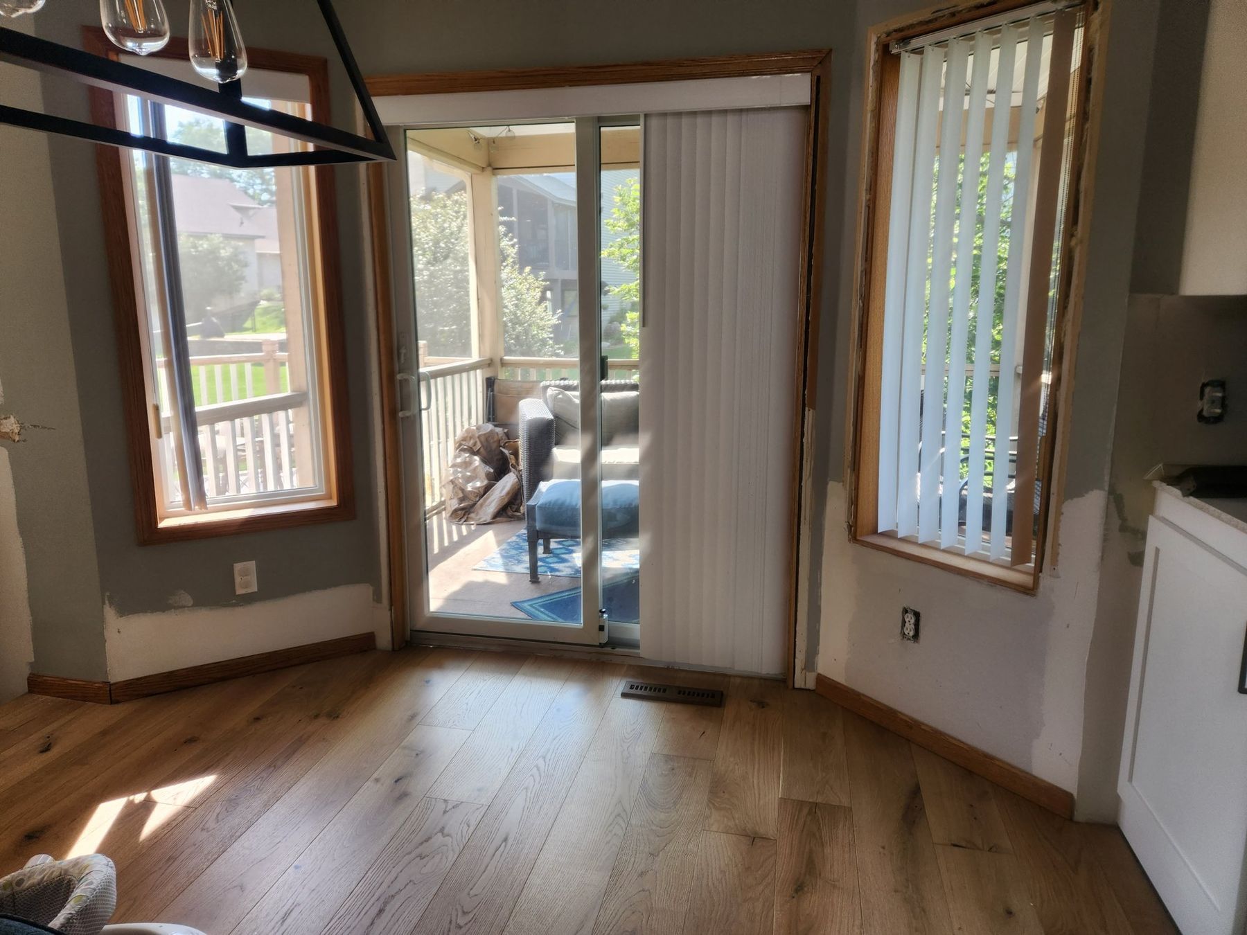 Before: golden oak window and patio door casings in the dining area