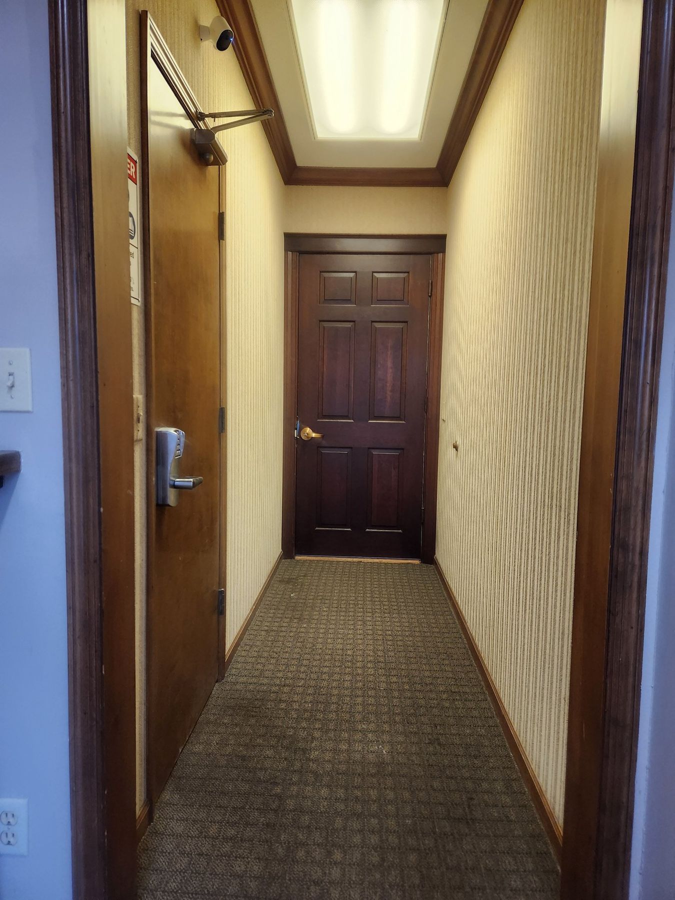 Before: striped wallpaper in the hallway
