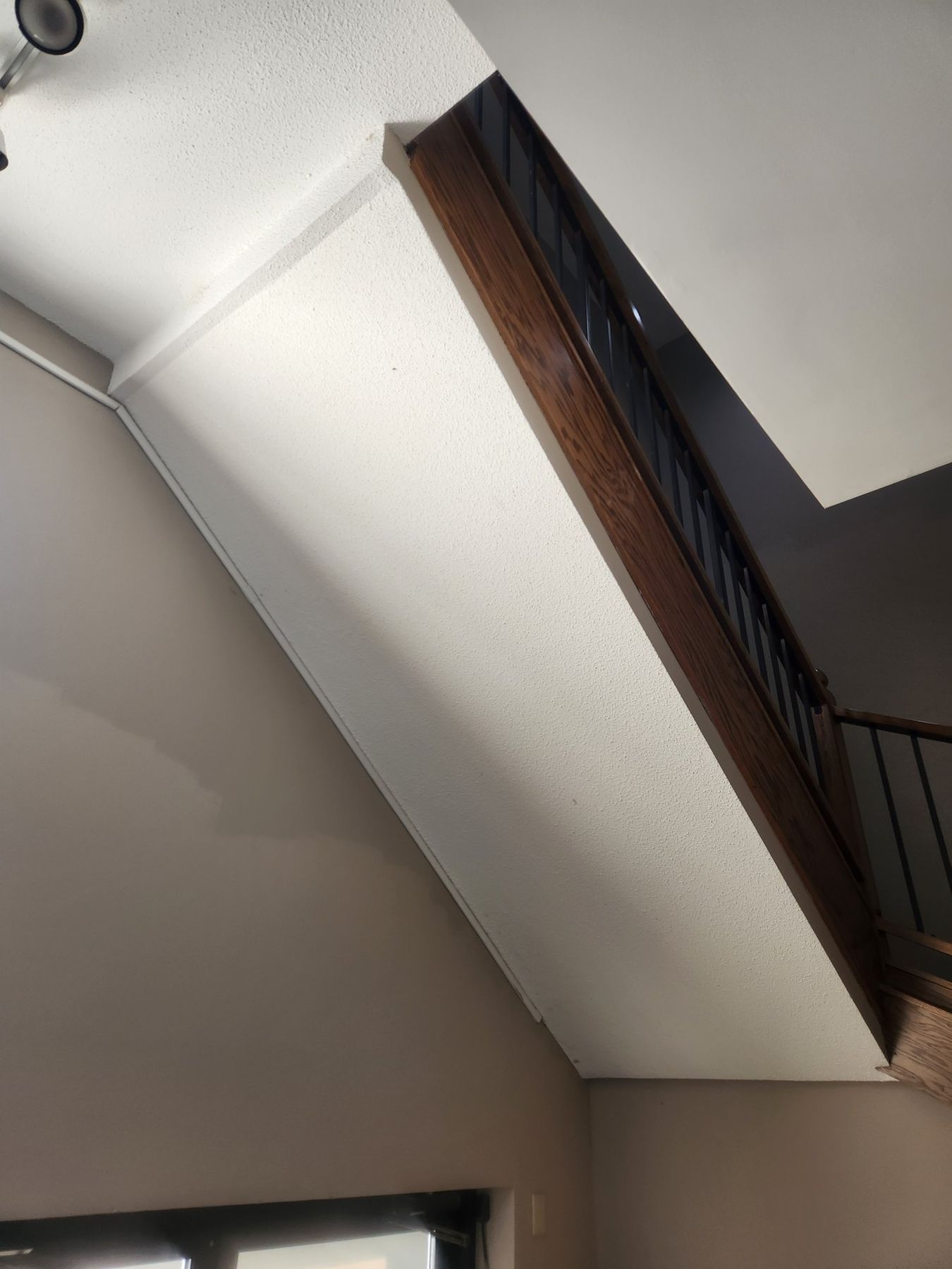 Before: stairwell ceiling with water staining
