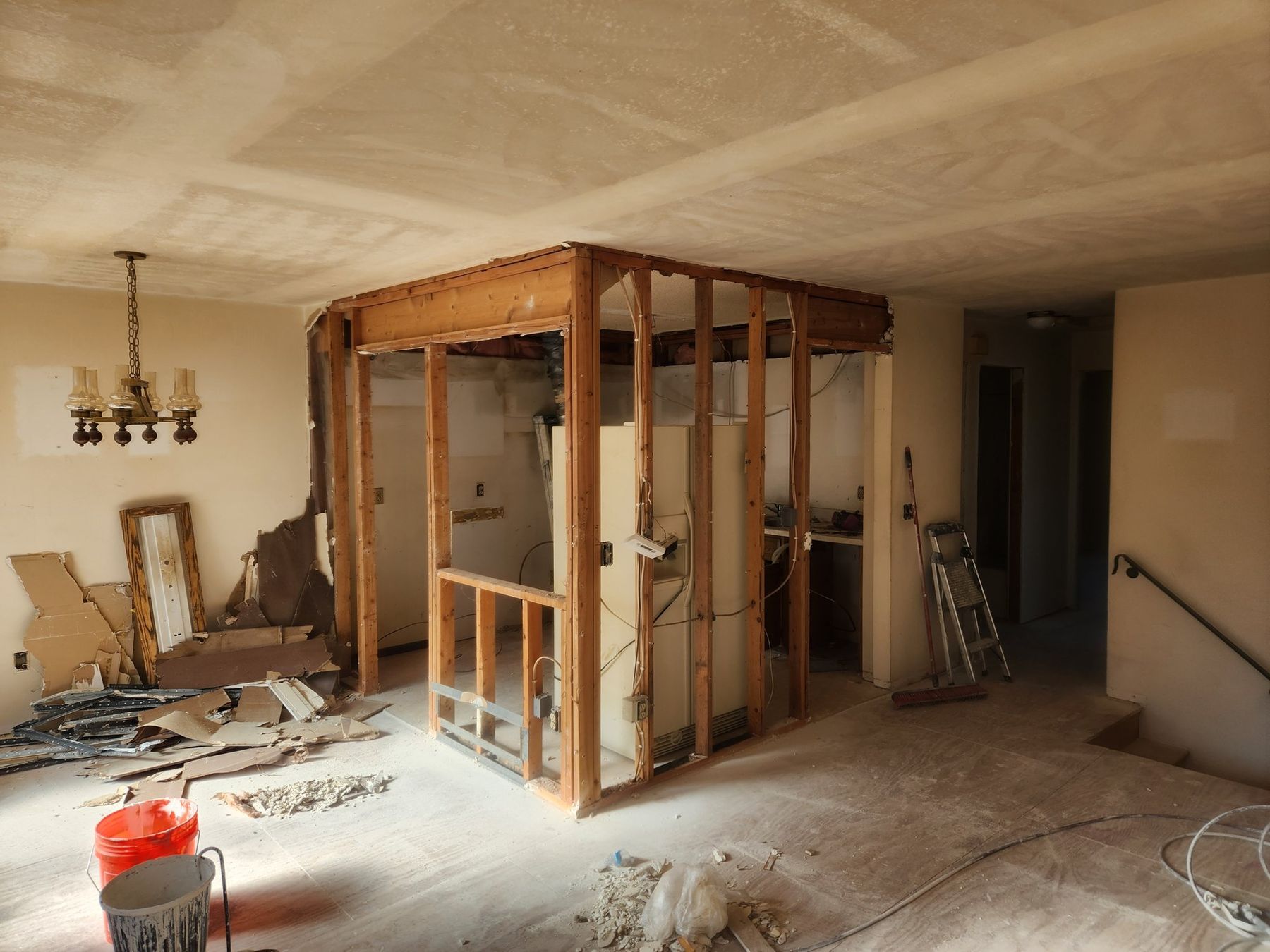Before: kitchen wall opened, popcorn ceiling still in place