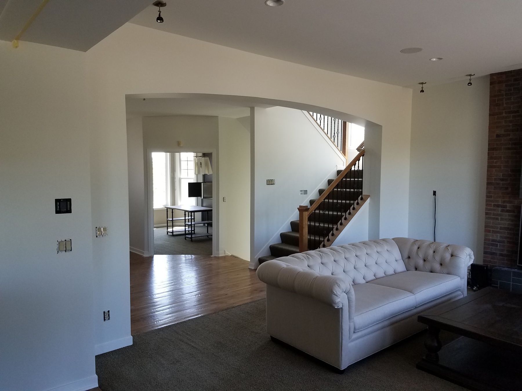 After: Great room toward the stair: sponged faux finish to smooth bright white