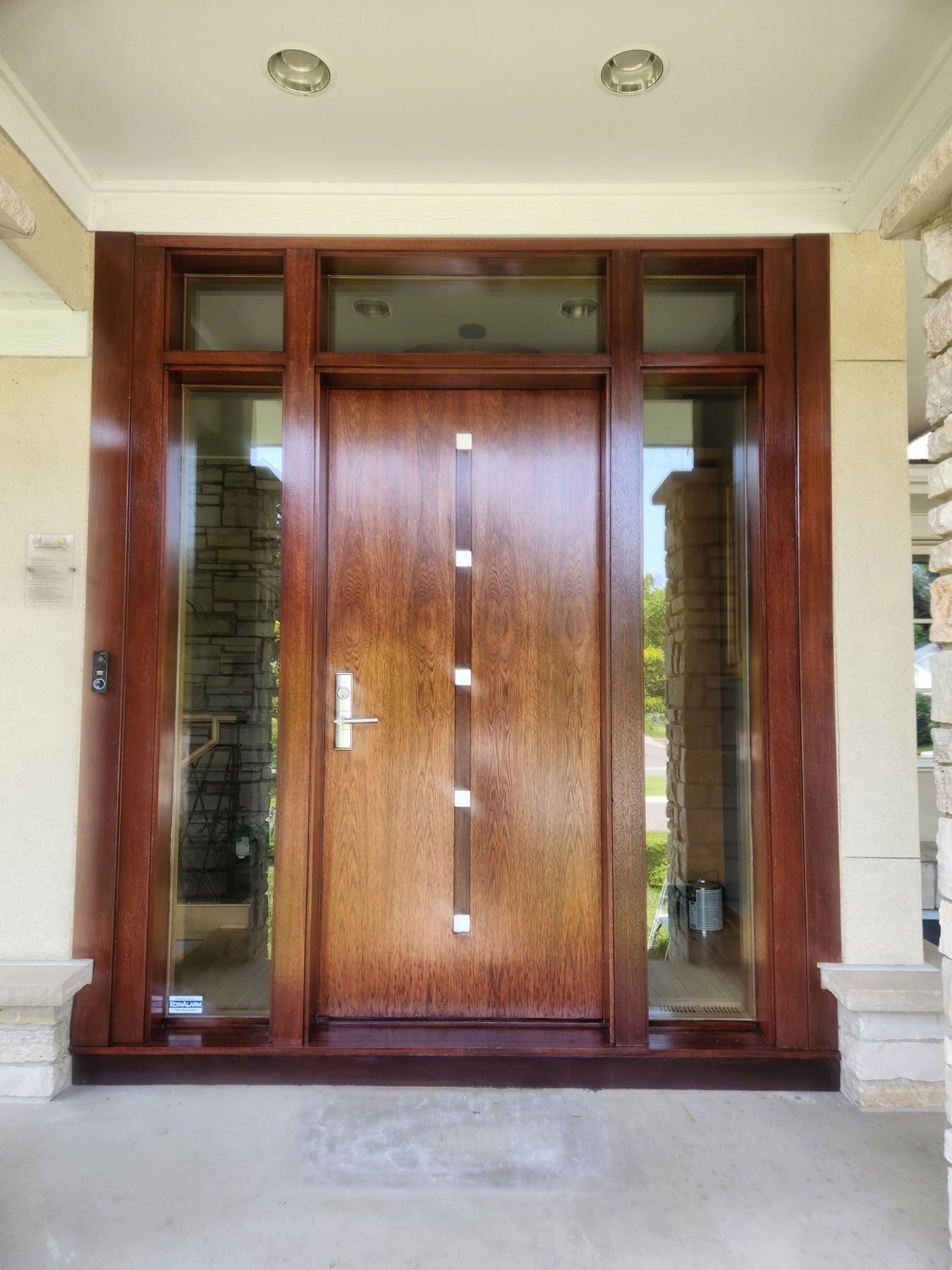 After: Entry door: faded, weathered finish to a restained, clear-coated door
