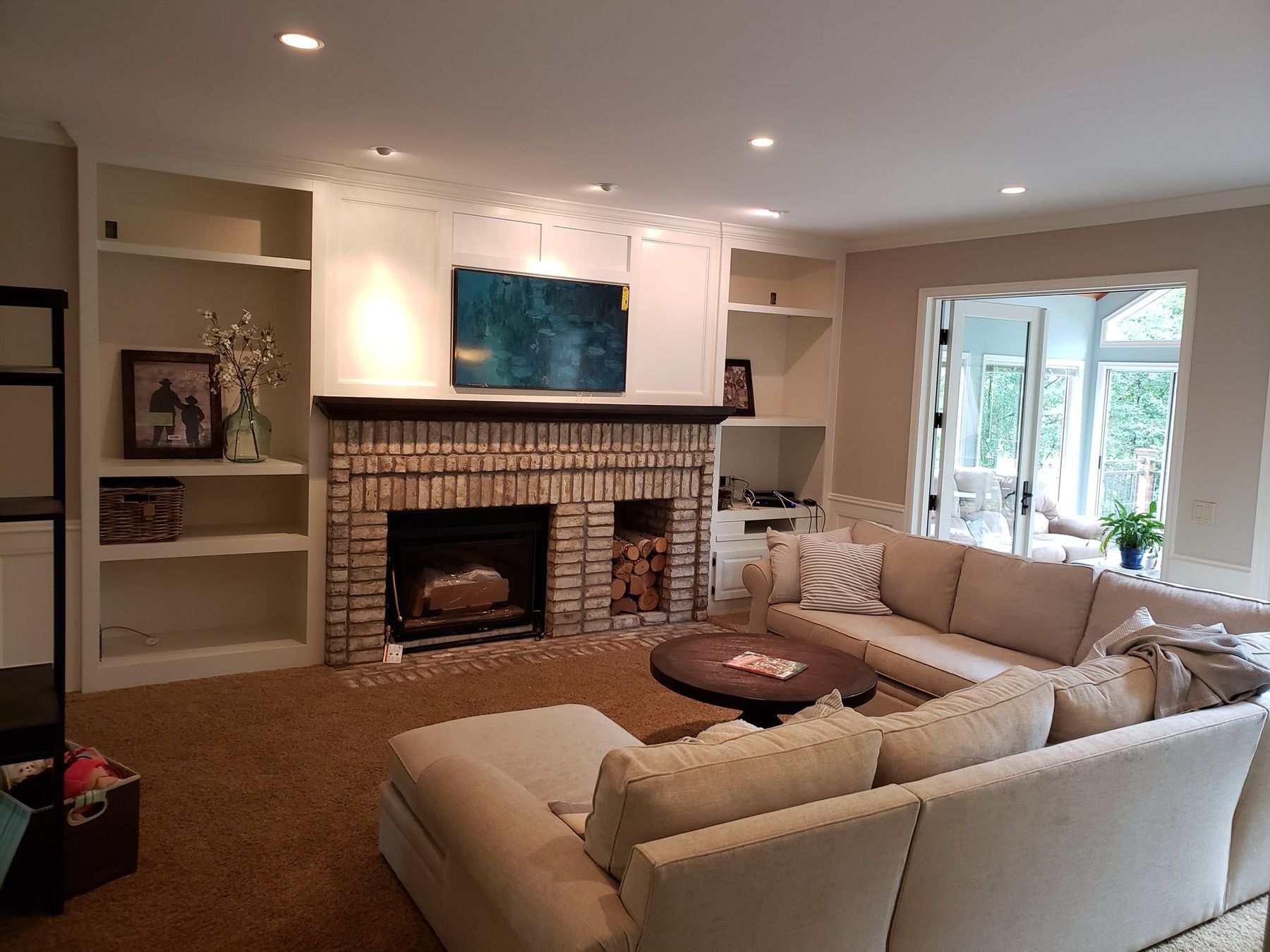 Family room built-ins and trim painted white after a golden oak conversion