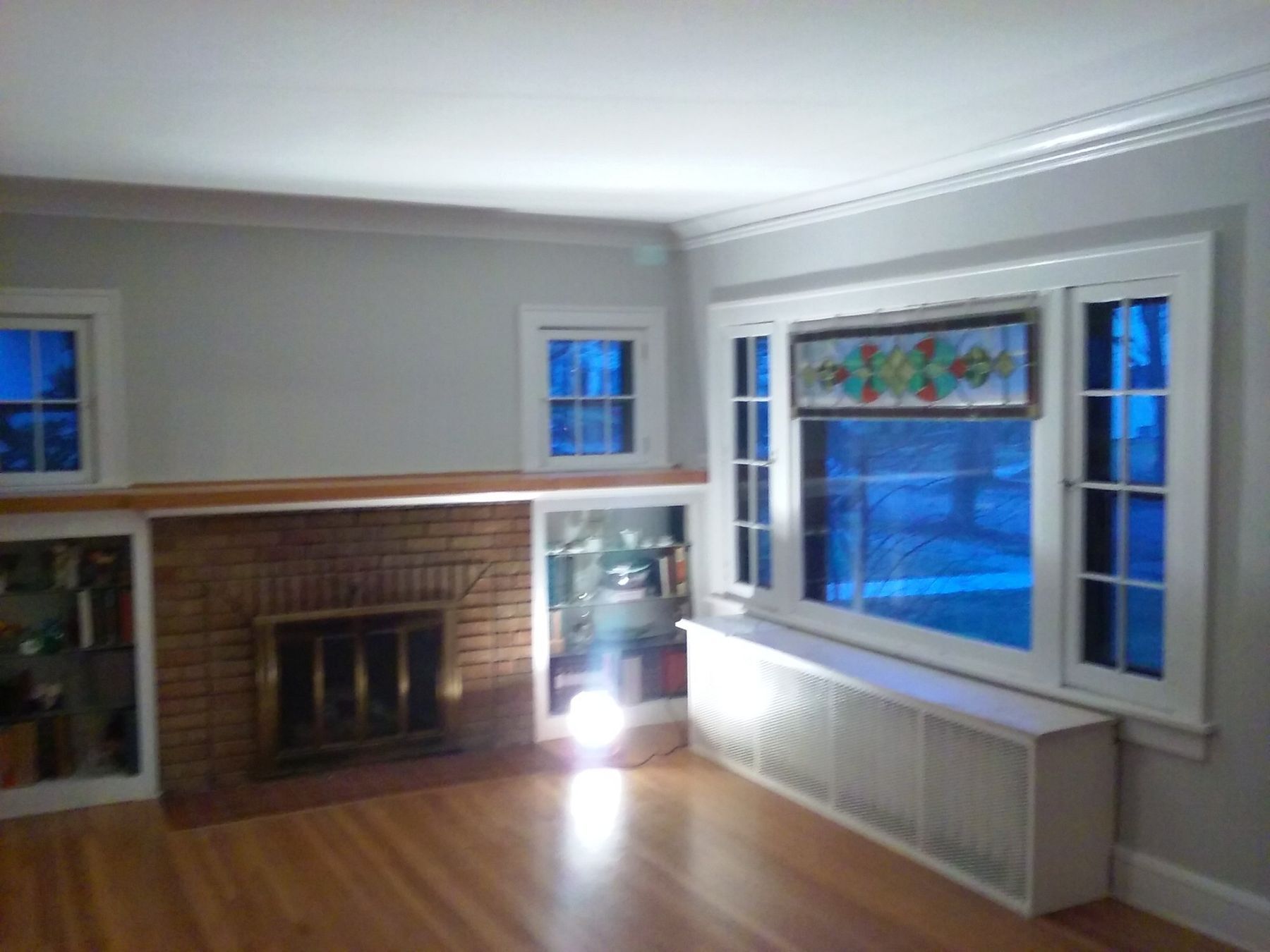 After: Living room fireplace wall: cream walls to light gray with white trim