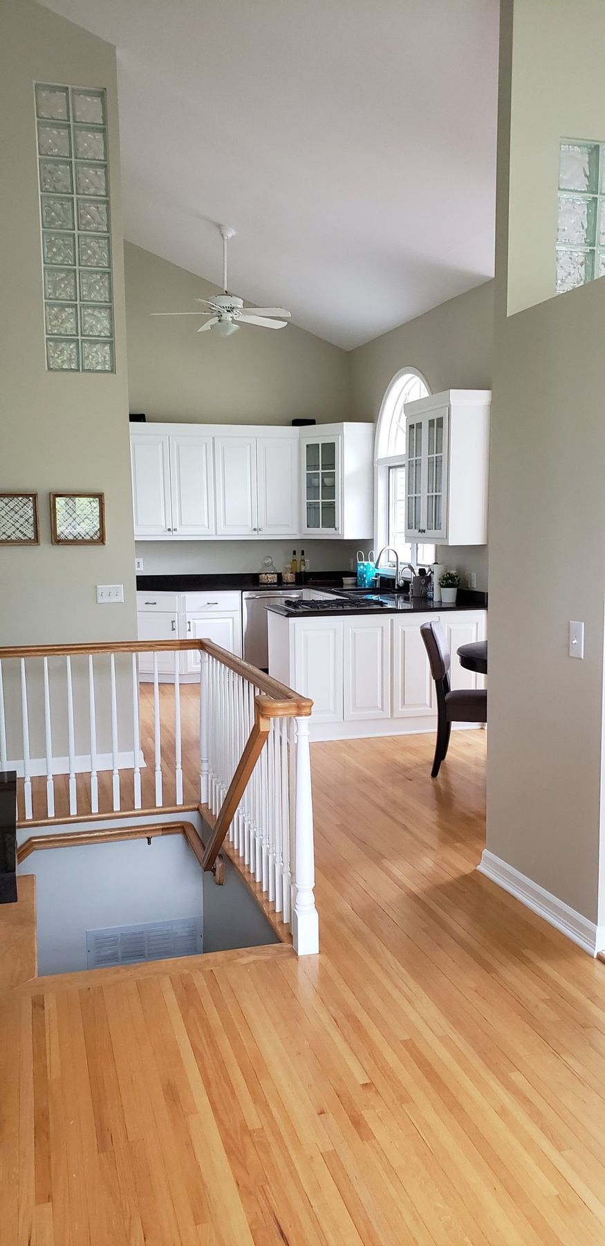 After: Kitchen and stair: golden oak cabinets, rail and trim painted white