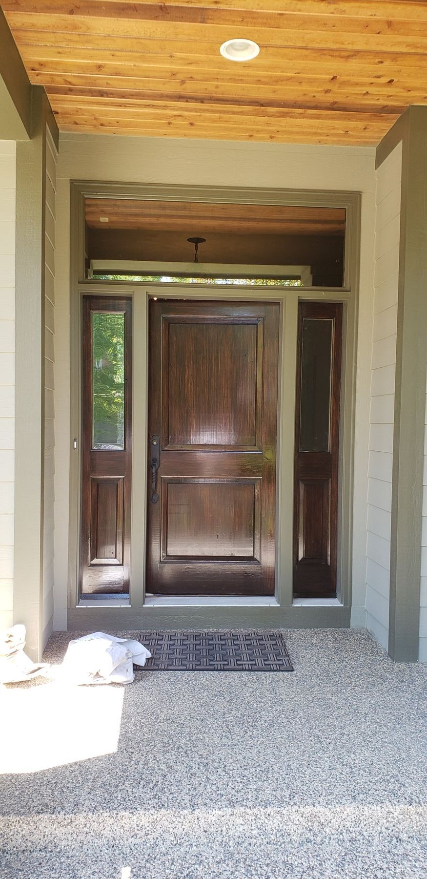 After: Front door and sidelights: faded orange finish to a deep brown gel stain under spar varnish