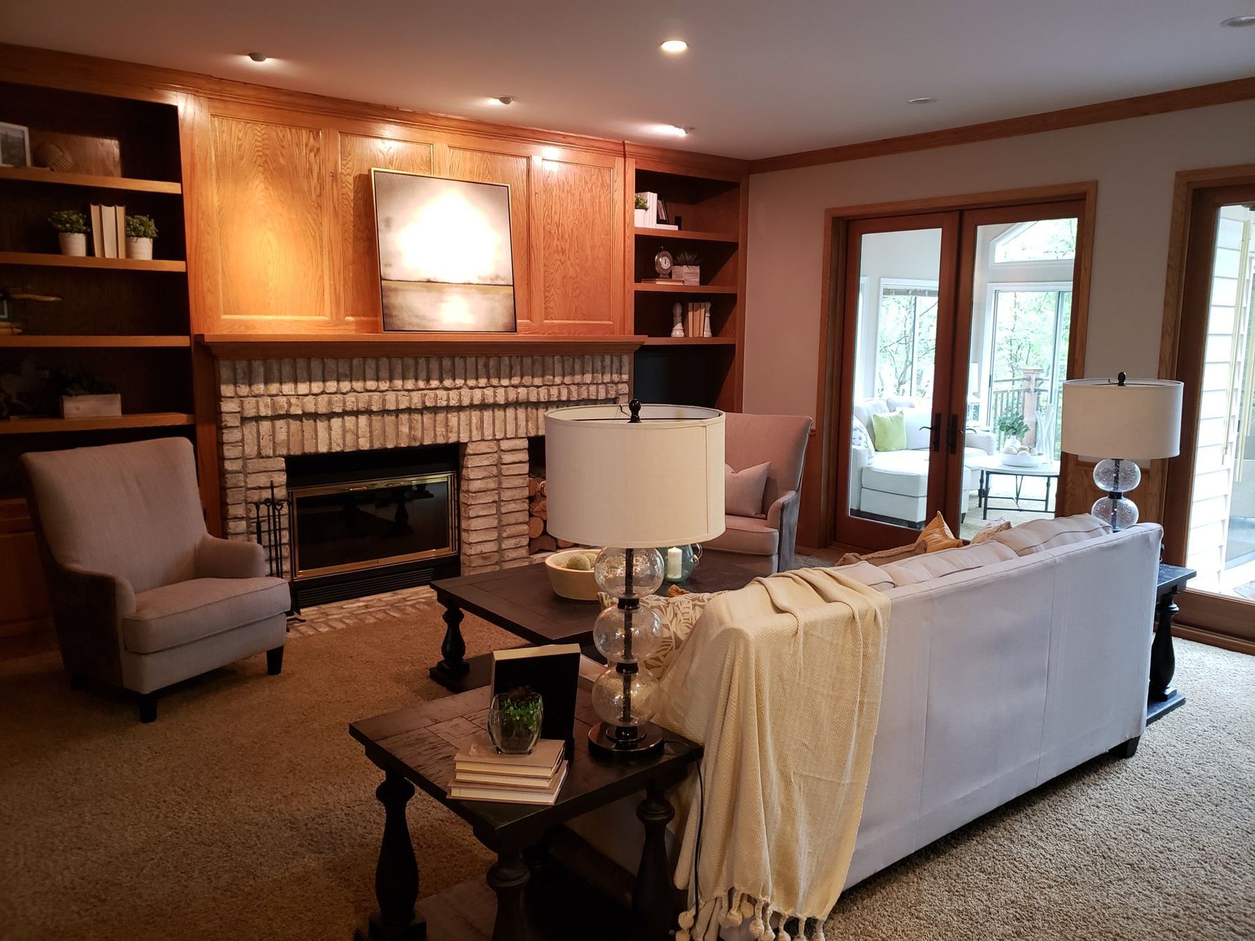 Before: Family room: golden oak built-ins, fireplace surround and trim painted white