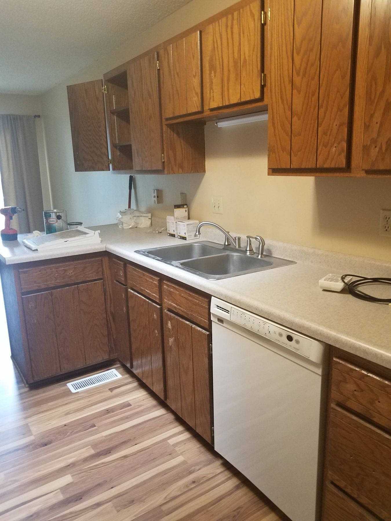 Before: Sink wall: golden oak cabinets to off-white