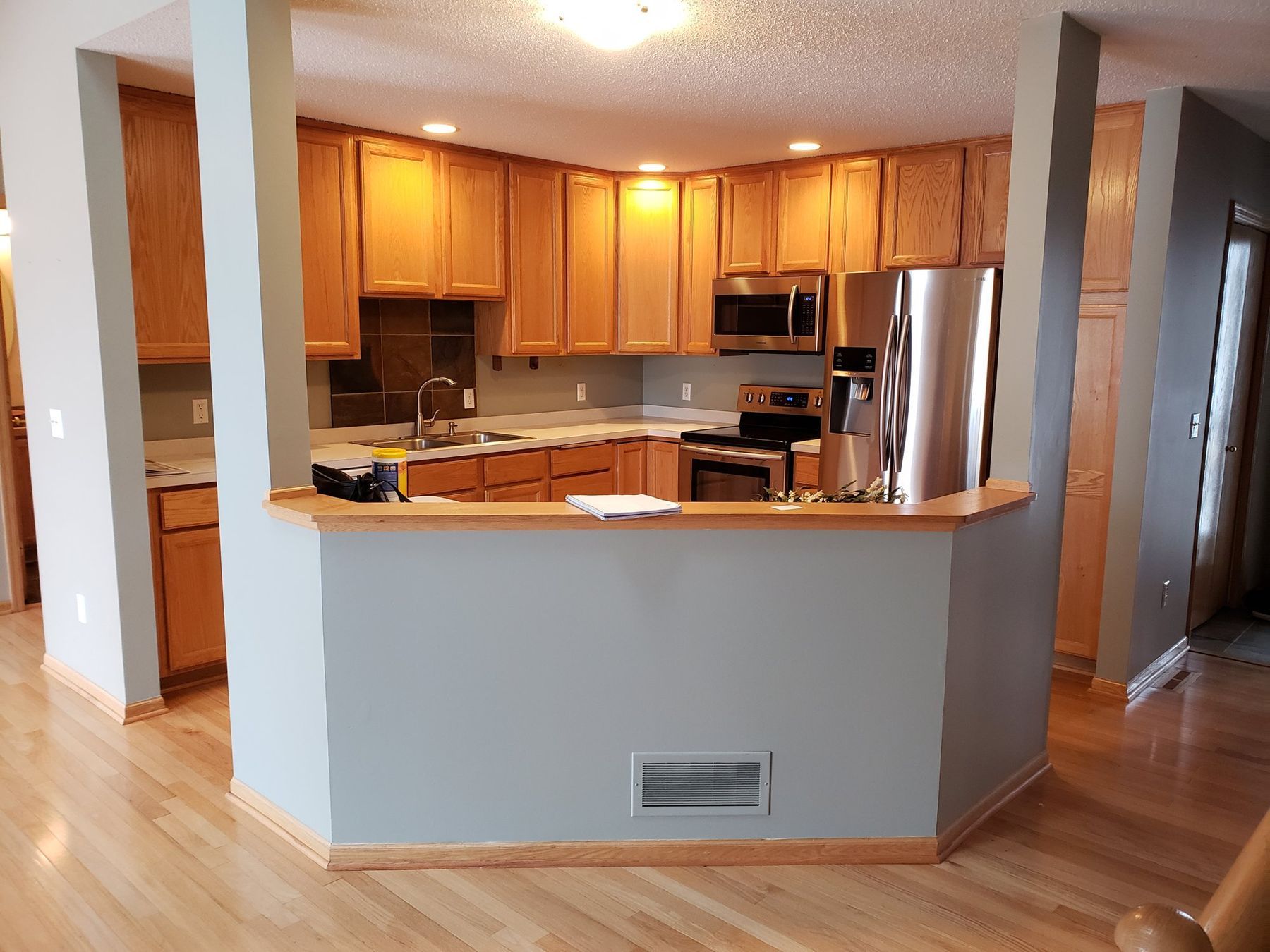 Before: Kitchen: golden oak cabinets sprayed white