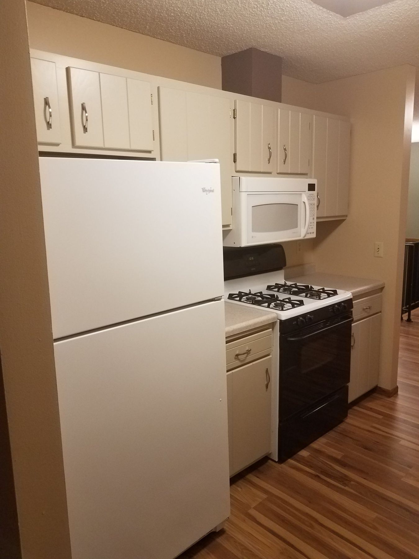 After: Range wall: golden oak cabinets to off-white