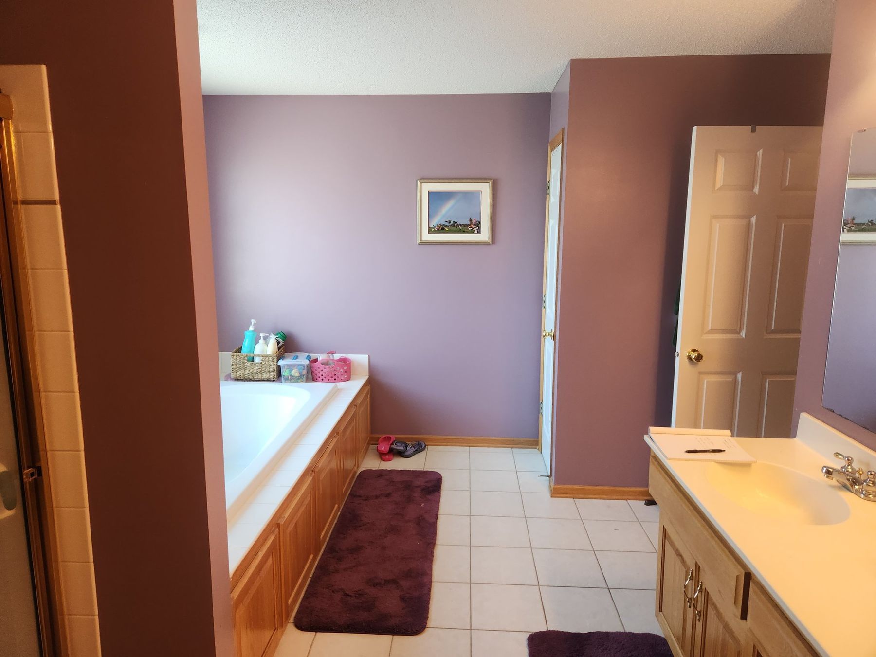 Before: Primary bath: plum walls repainted light gray