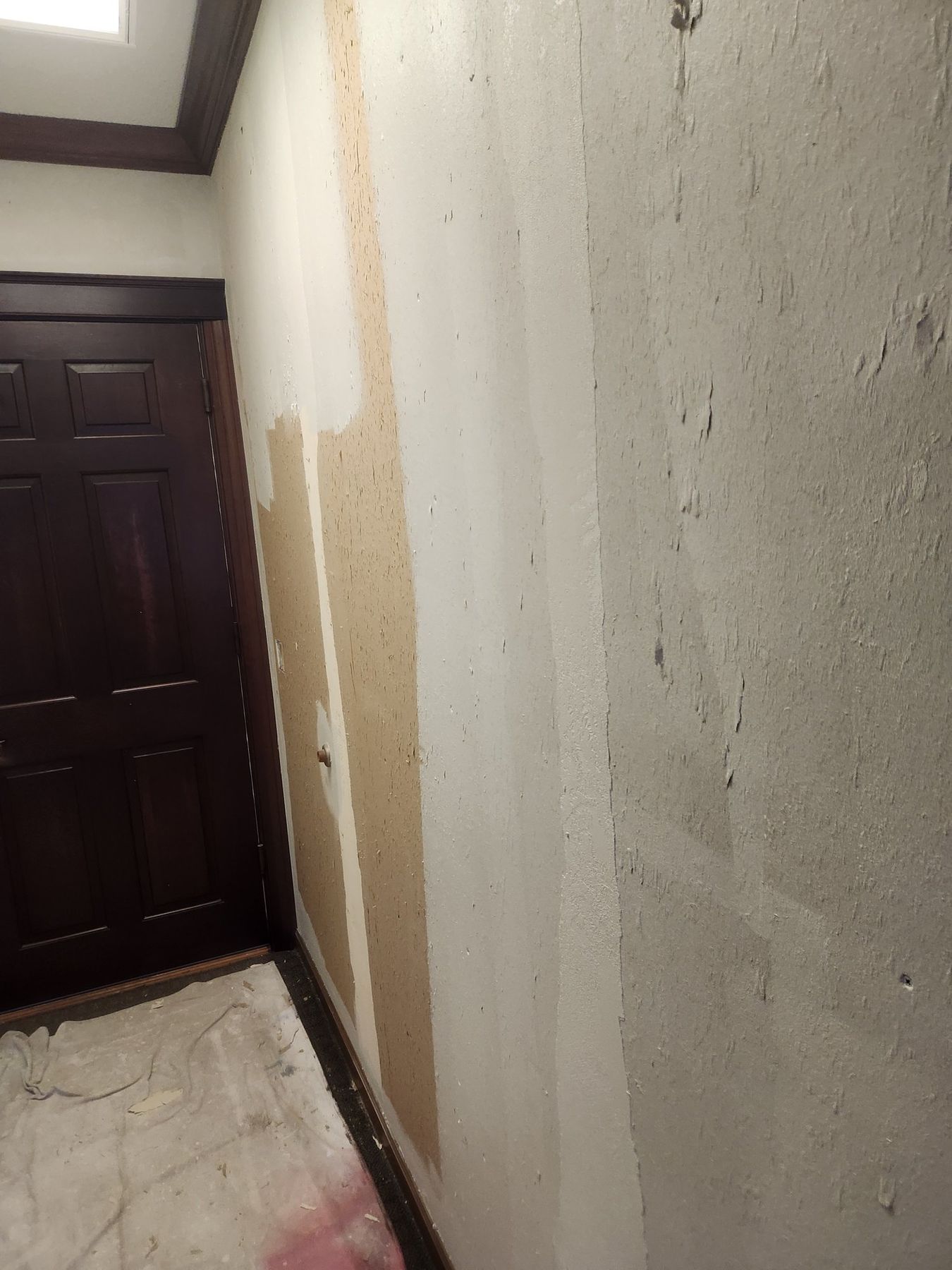 Hallway walls after the wallpaper came off, patched