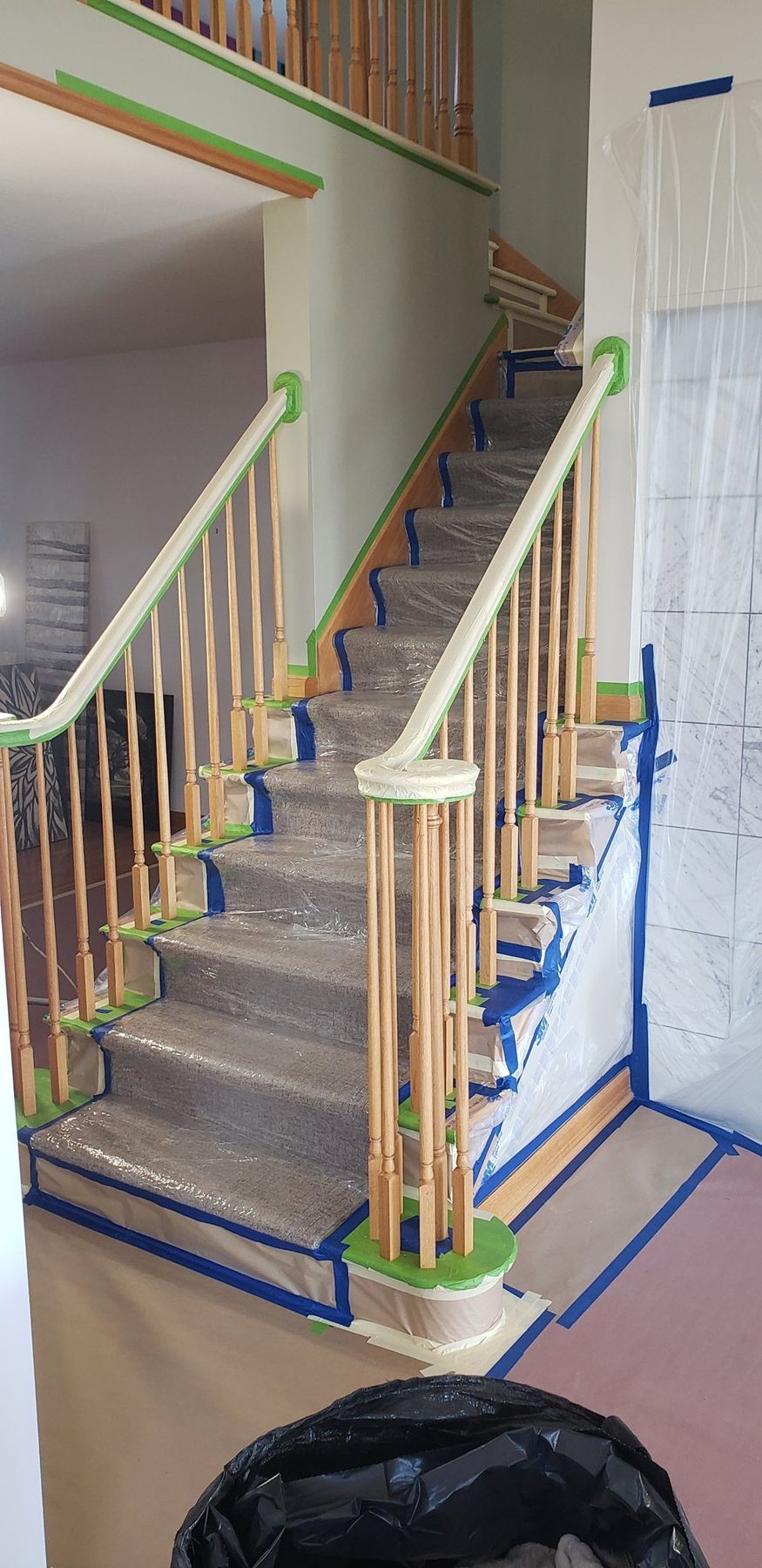 Stair spindles and treads masked for priming