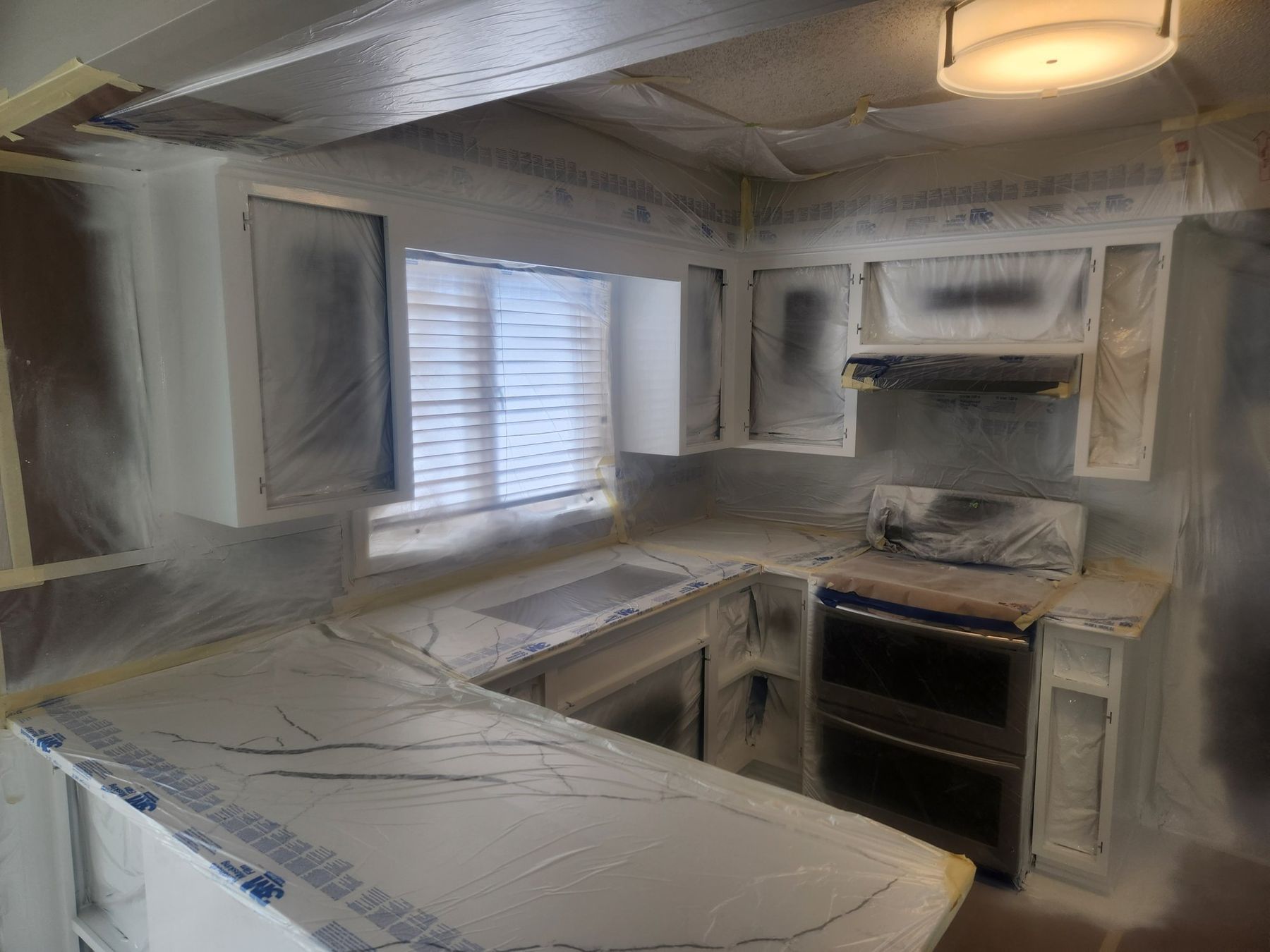 Kitchen masked in plastic for spraying the frames