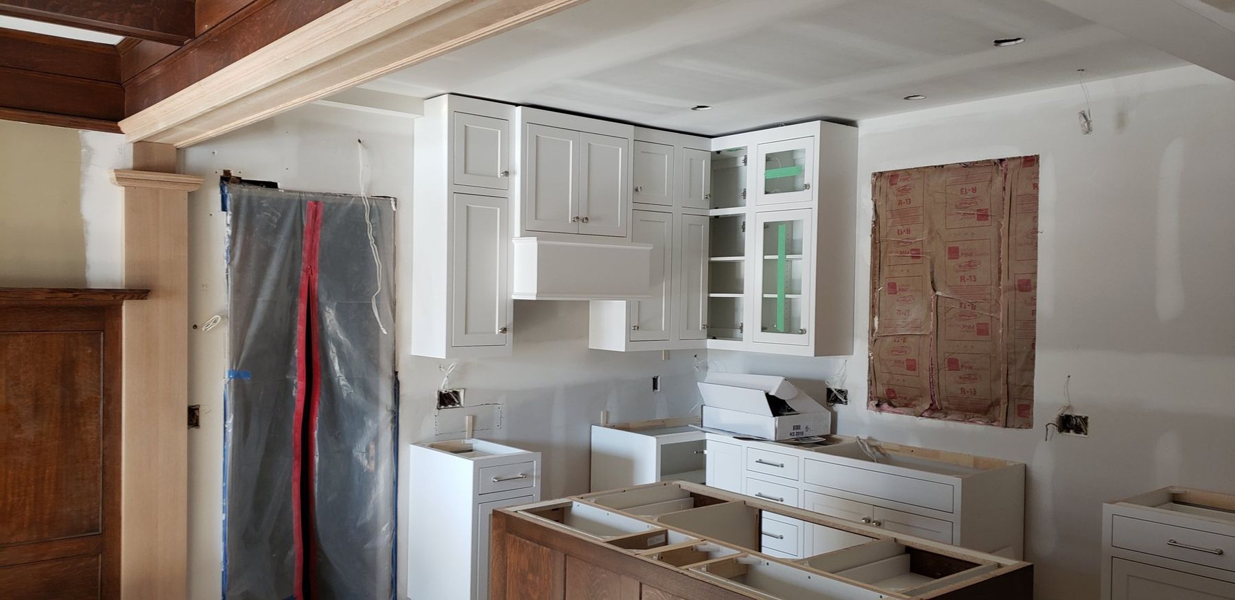 Kitchen mid-remodel behind plastic barriers