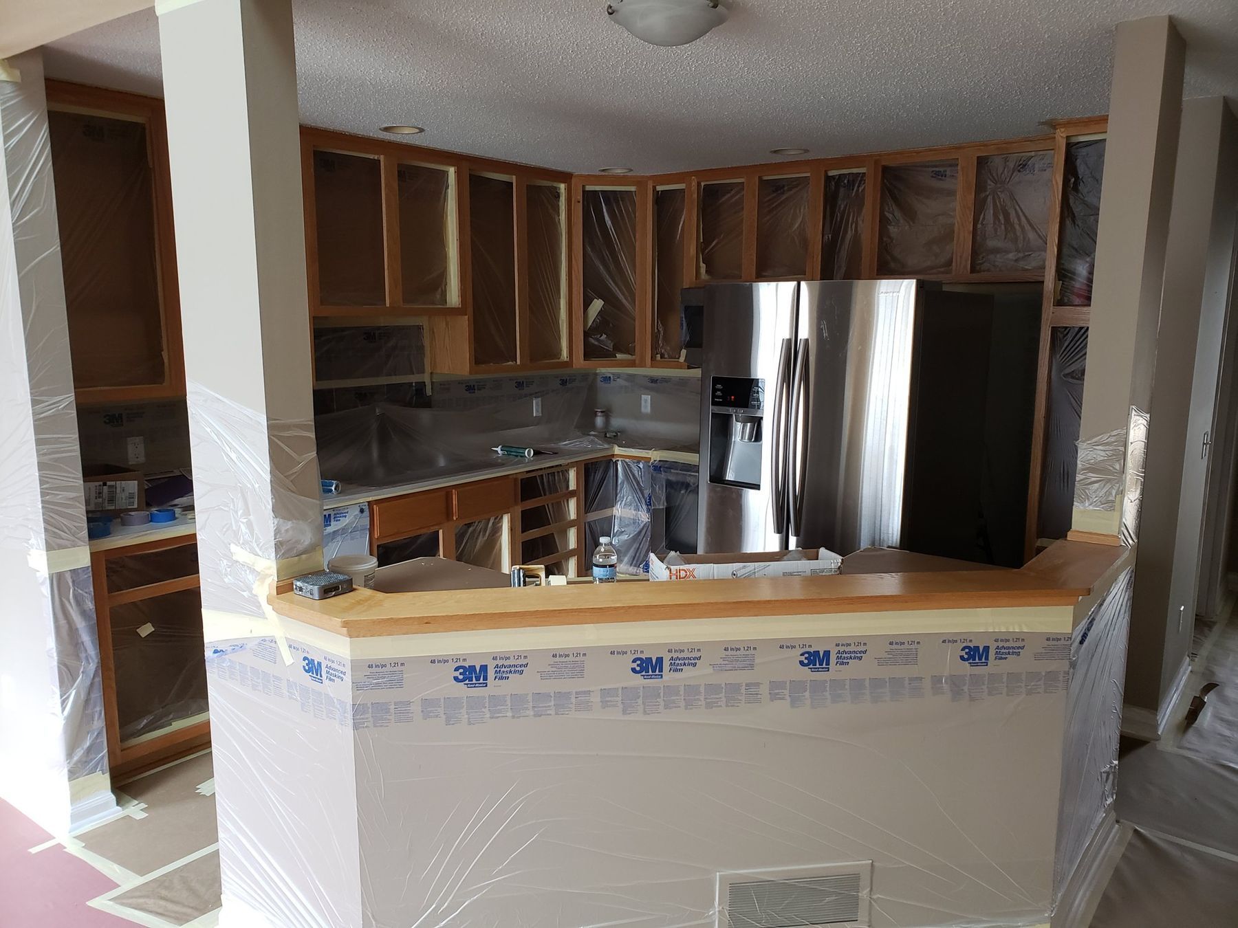 Cabinet frames masked, countertops and appliances covered