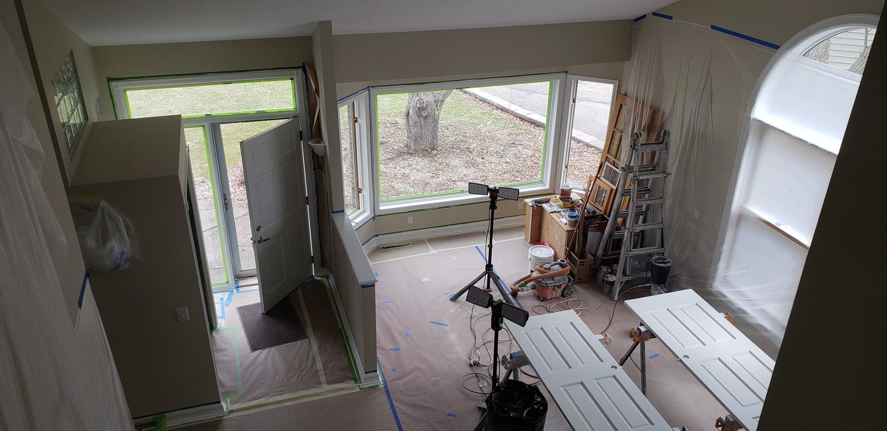French doors and sunroom prepped, floors covered