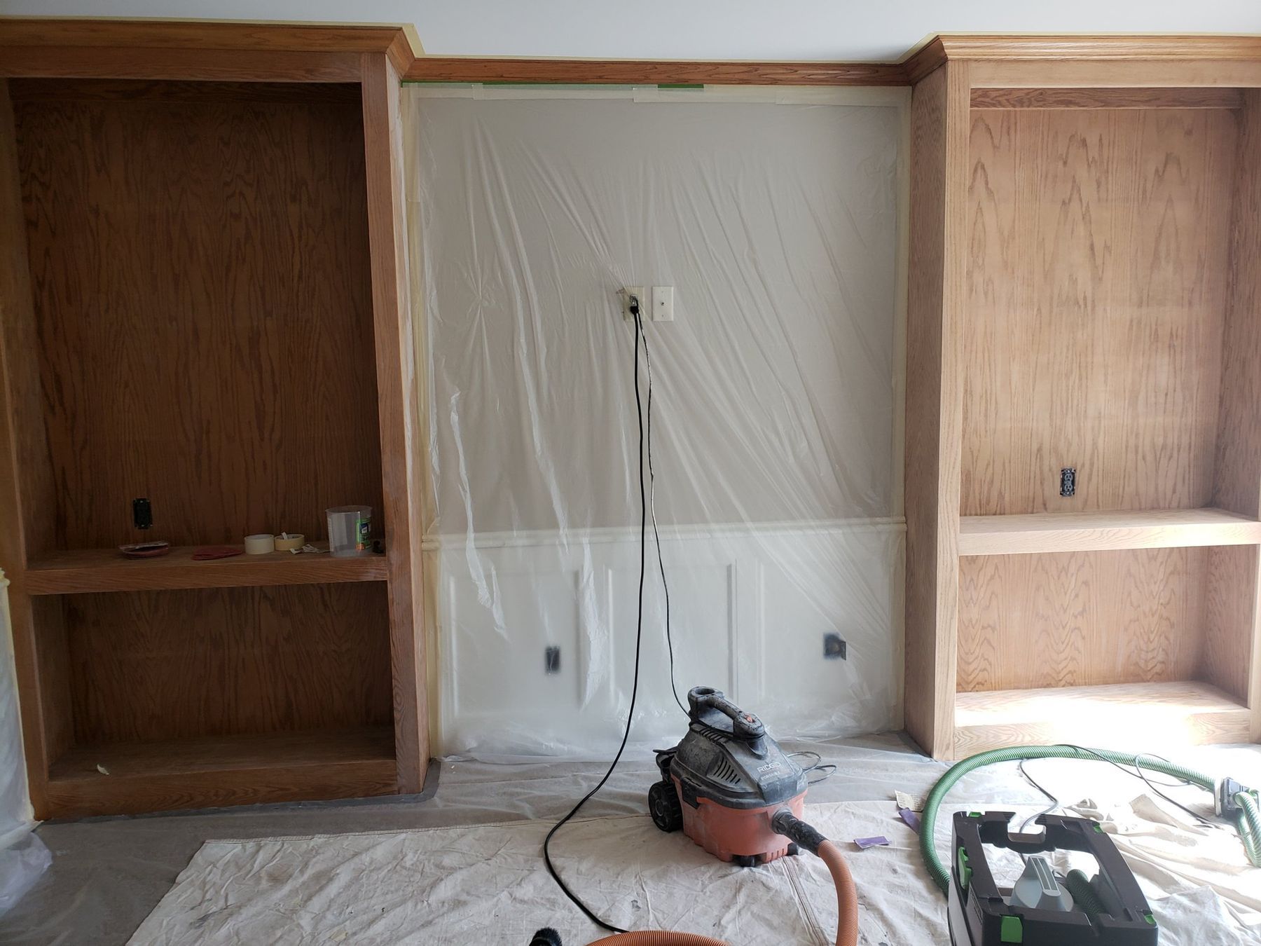 Den built-ins masked and prepped for stain