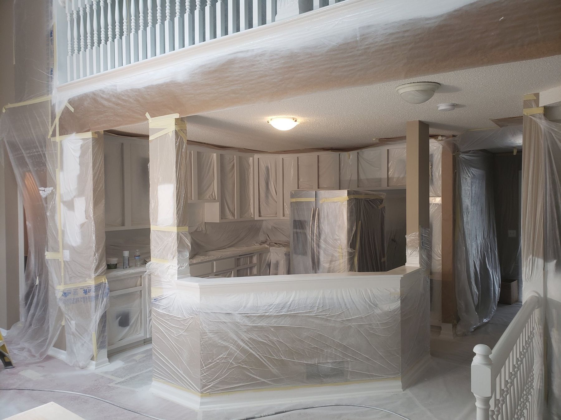 Primed cabinet frames inside full plastic containment