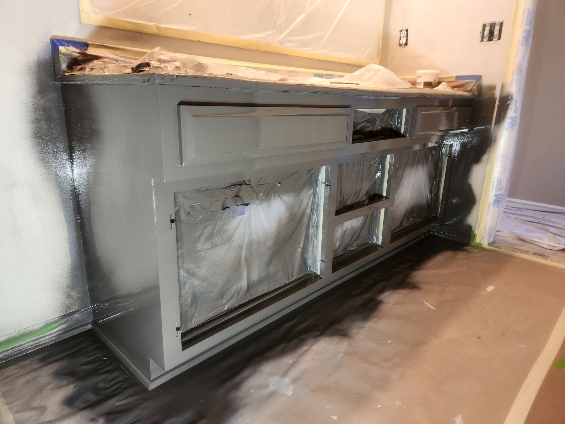 First dark coat sprayed on the vanity base